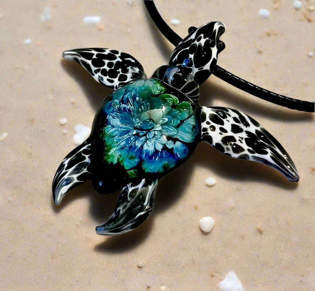 glass black and white spotted sea turtle pendant with iceberg style explosion in the shell at a 60 degree angle.