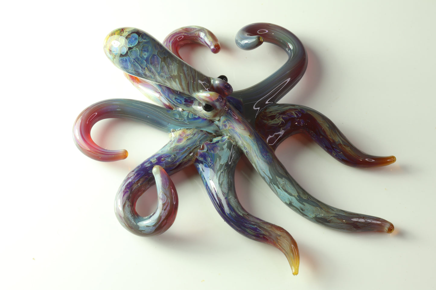 Purple glass spreading octopus pendant